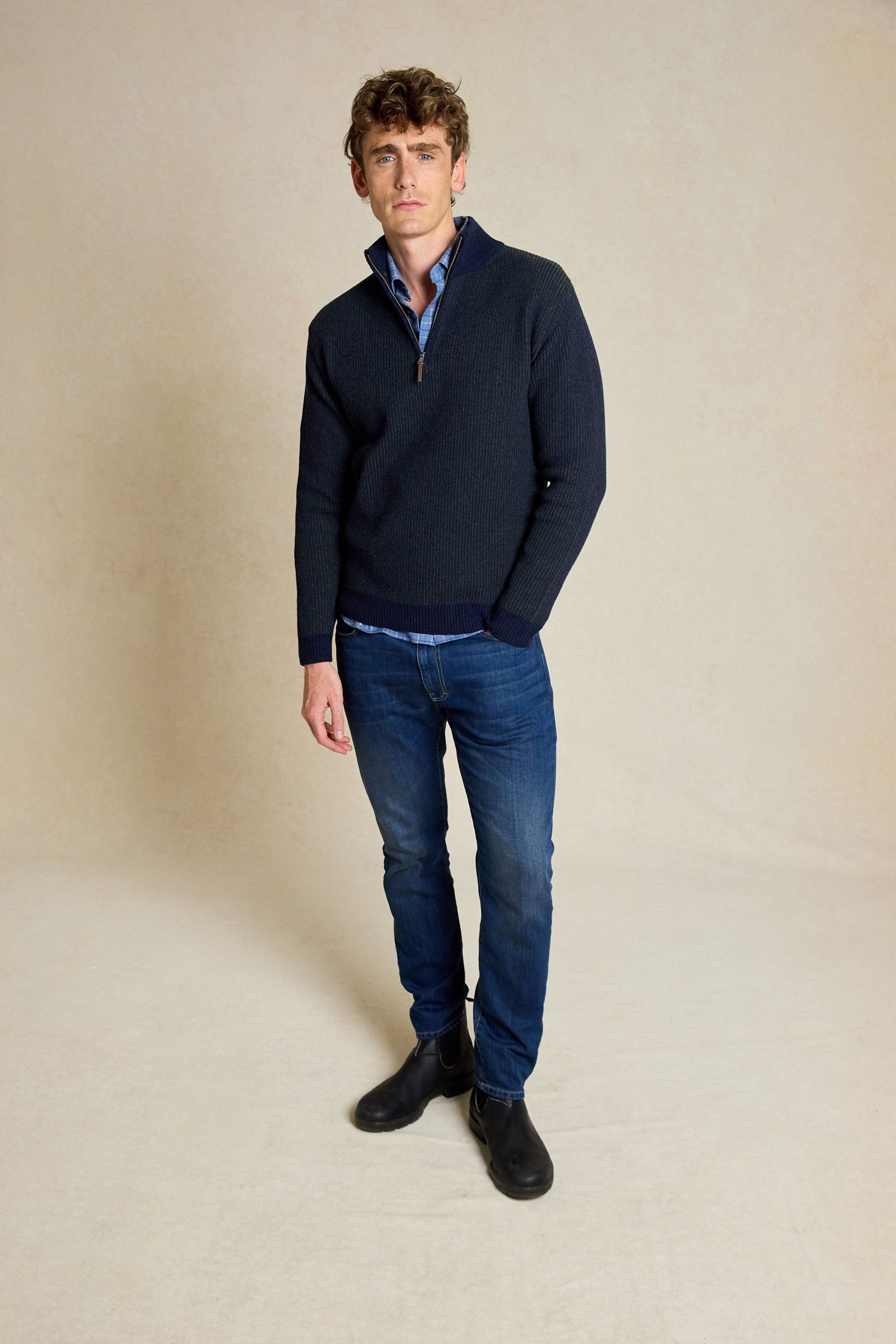 Elevate your wardrobe with the Bellever Navy Rib Half Zip Jumper. This versatile piece features a classic ribbed design and half zip neck for a stylish yet comfortable fit.