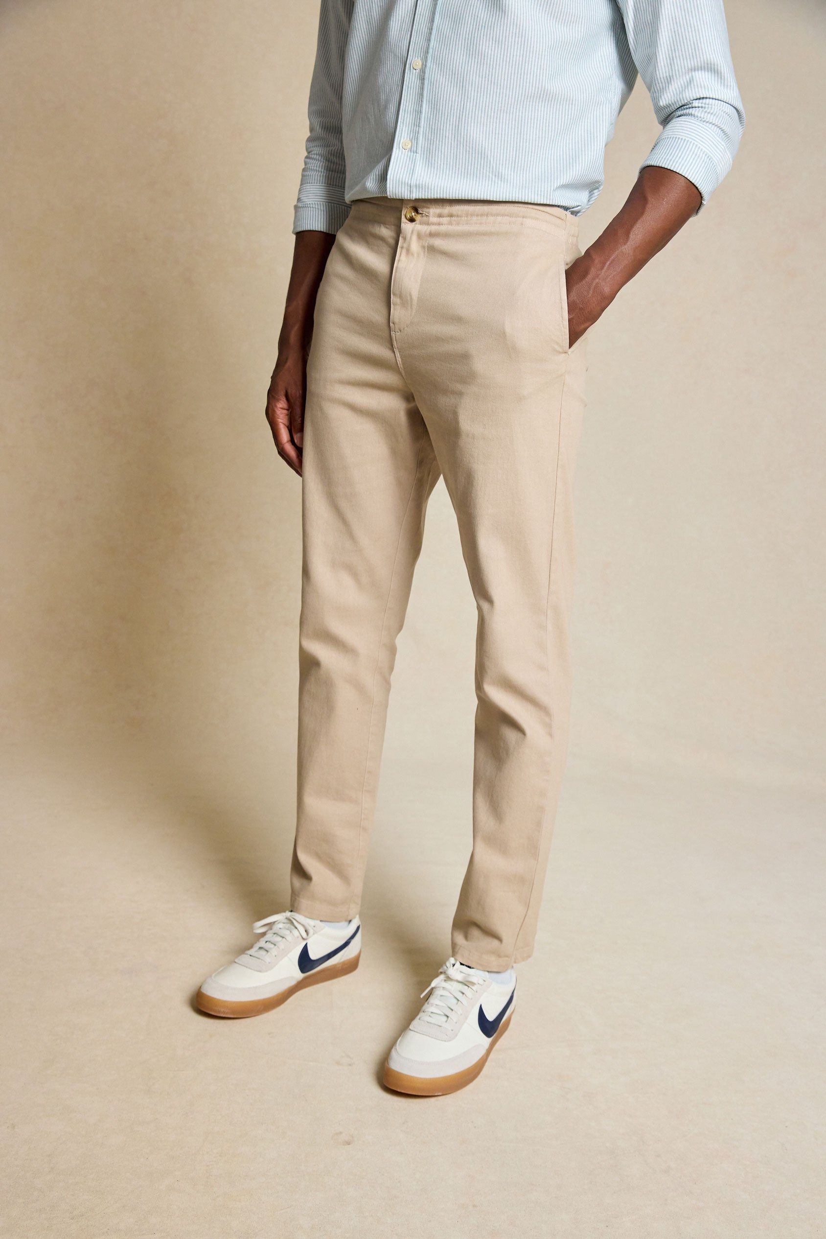 Discover the perfect blend of comfort and style with the Carrick Sand Drawstring Chinos. Featuring an adjustable drawstring waist, these versatile chinos offer a relaxed fit with a modern, tailored look.