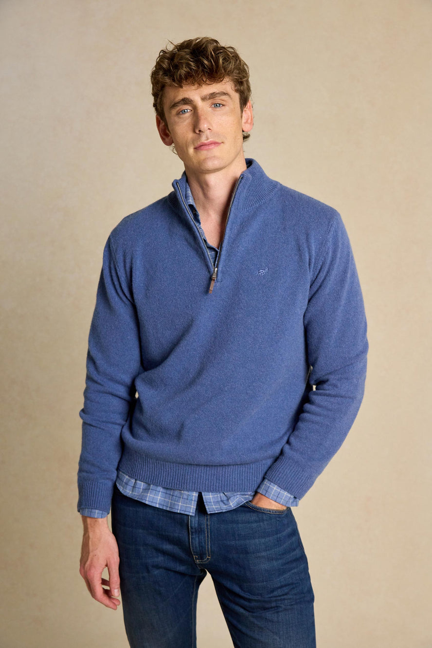 Enhance your wardrobe with the Colesbourne Denim Blue Half Zip Jumper. Made from 100% Italian lambswool, this jumper combines comfort and warmth with timeless style.