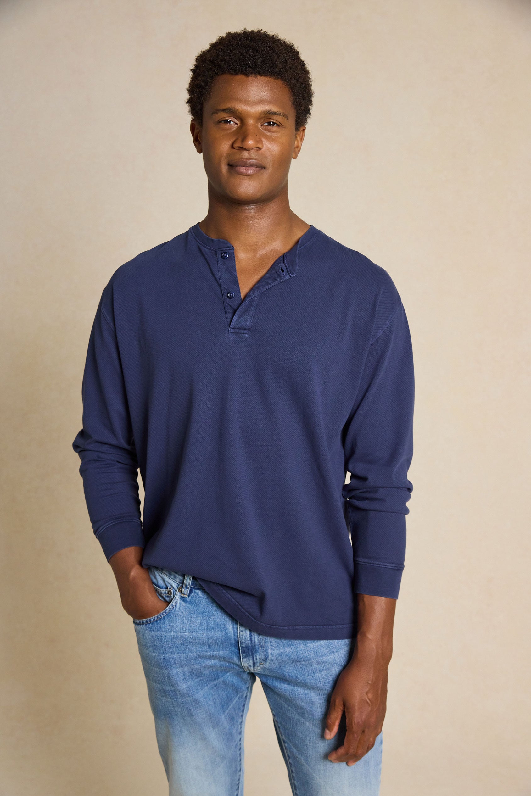 Enhance your casual style with the Fleet Navy Half Button Henley Top. This versatile piece features a classic crew neck half-button design, creating a comfortable yet timeless look.