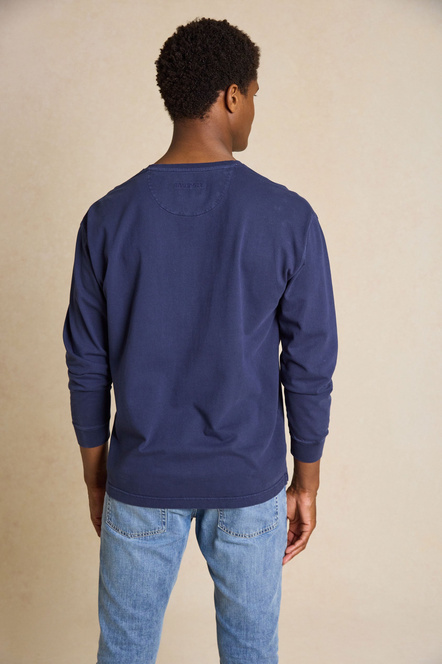 Enhance your casual style with the Fleet Navy Half Button Henley Top. This versatile piece features a classic crew neck half-button design, creating a comfortable yet timeless look.