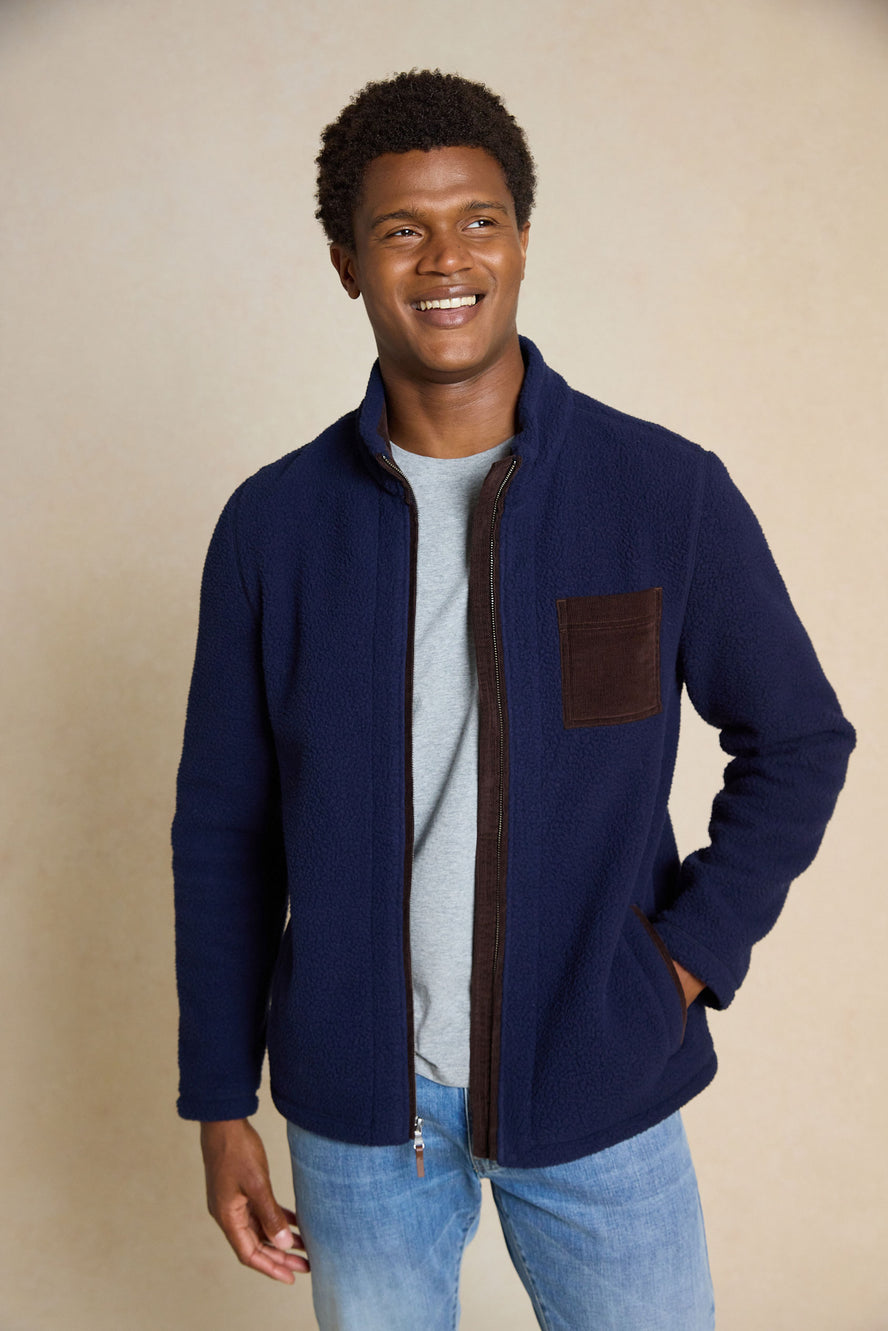 Upgrade your wardrobe with the Macclesfield Navy Sherpa Jacket. Featuring cord details and unique back neck elephant embroidery, this jacket blends rugged style with refined touches.