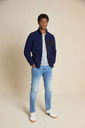 Upgrade your wardrobe with the Macclesfield Navy Sherpa Jacket. Featuring cord details and unique back neck elephant embroidery, this jacket blends rugged style with refined touches.