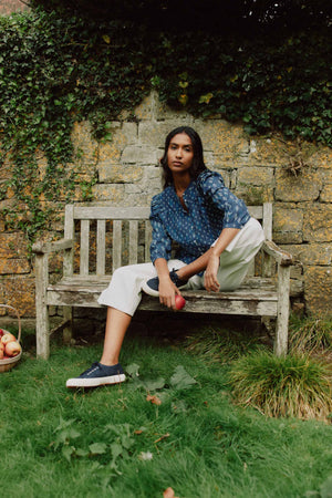 Embrace effortless style with the Molesley Blues Ruffle Printed Top. Indigo-dyed with a bespoke print. This shirt combines a classic Nehru collar with delicate ruffle details.