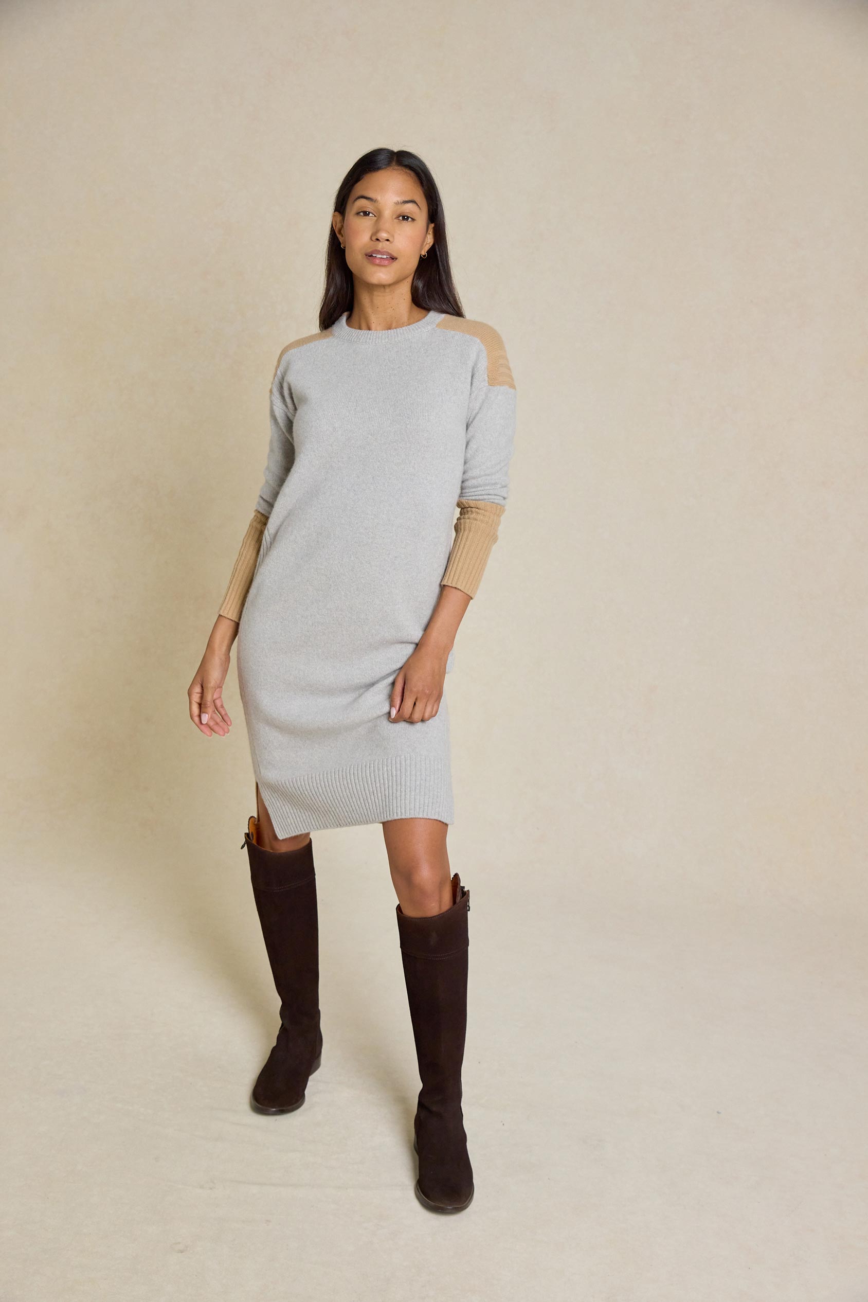 Step out in style with the Naden Grey Knitted Dress. This dress features a classic crew neck and striking color block details, perfect for an effortless look.