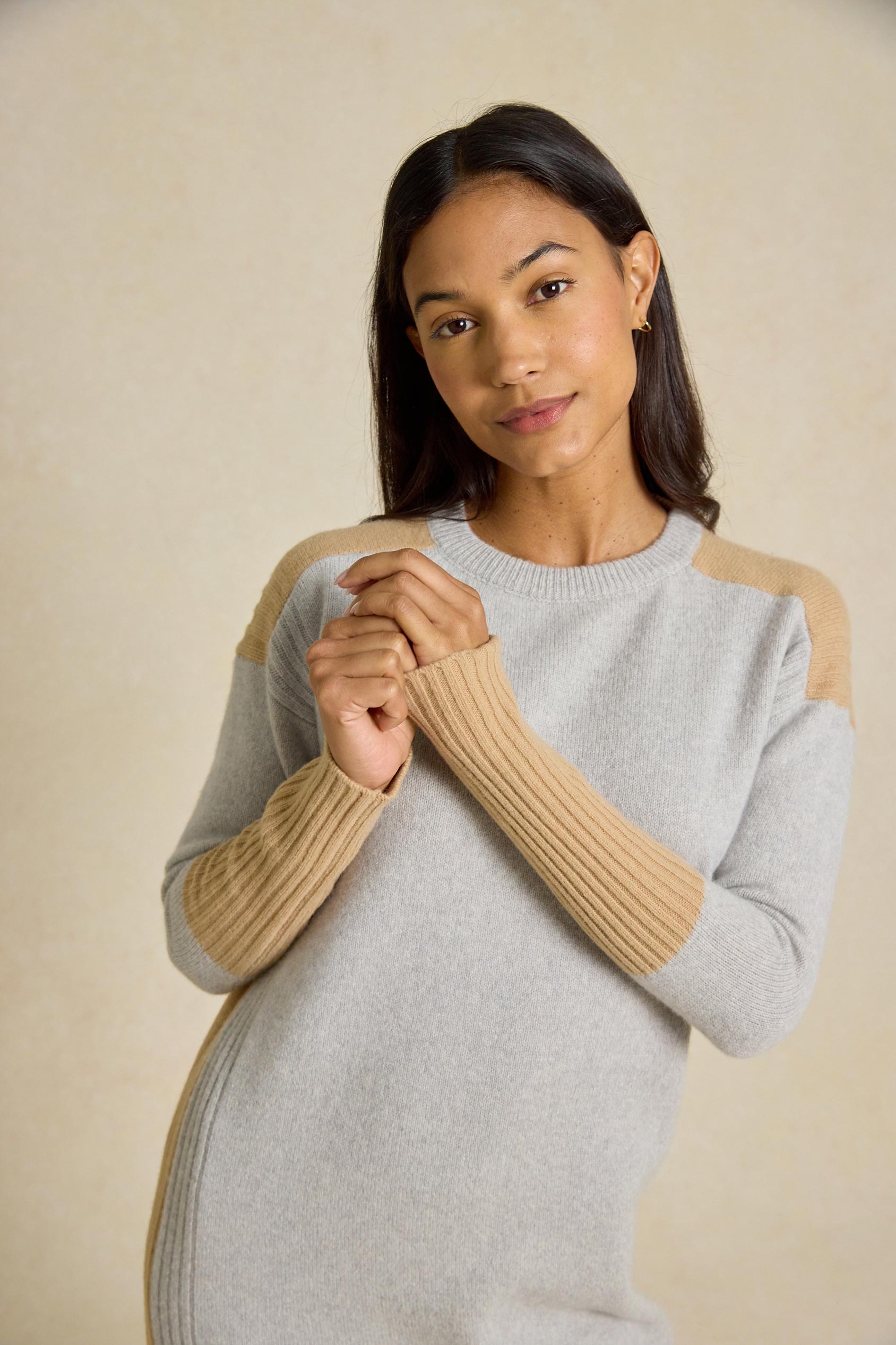 Step out in style with the Naden Grey Knitted Dress. This dress features a classic crew neck and striking color block details, perfect for an effortless look.