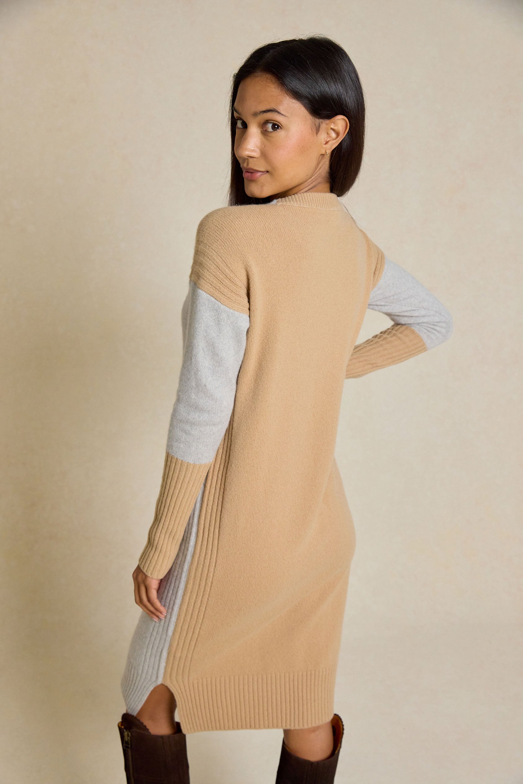 Step out in style with the Naden Grey Knitted Dress. This dress features a classic crew neck and striking color block details, perfect for an effortless look.