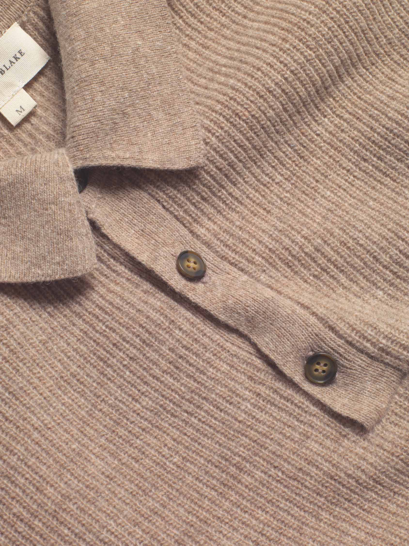 Elevate your winter style with the Winterfold Oat Polo Jumper. Crafted from luxurious Italian wool, this refined piece is hand wash only, ensuring long-lasting quality and comfort.